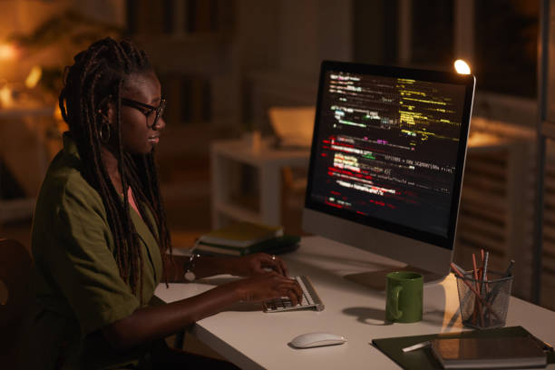 black girl with glasses - coding on computer